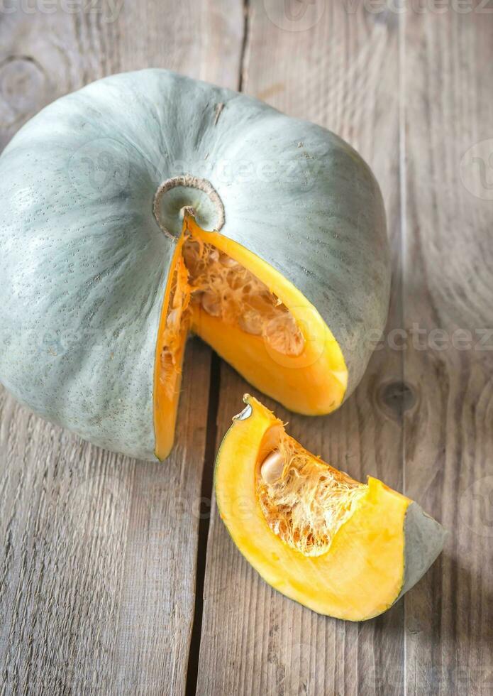 Ripe pumpkin on the wooden background photo
