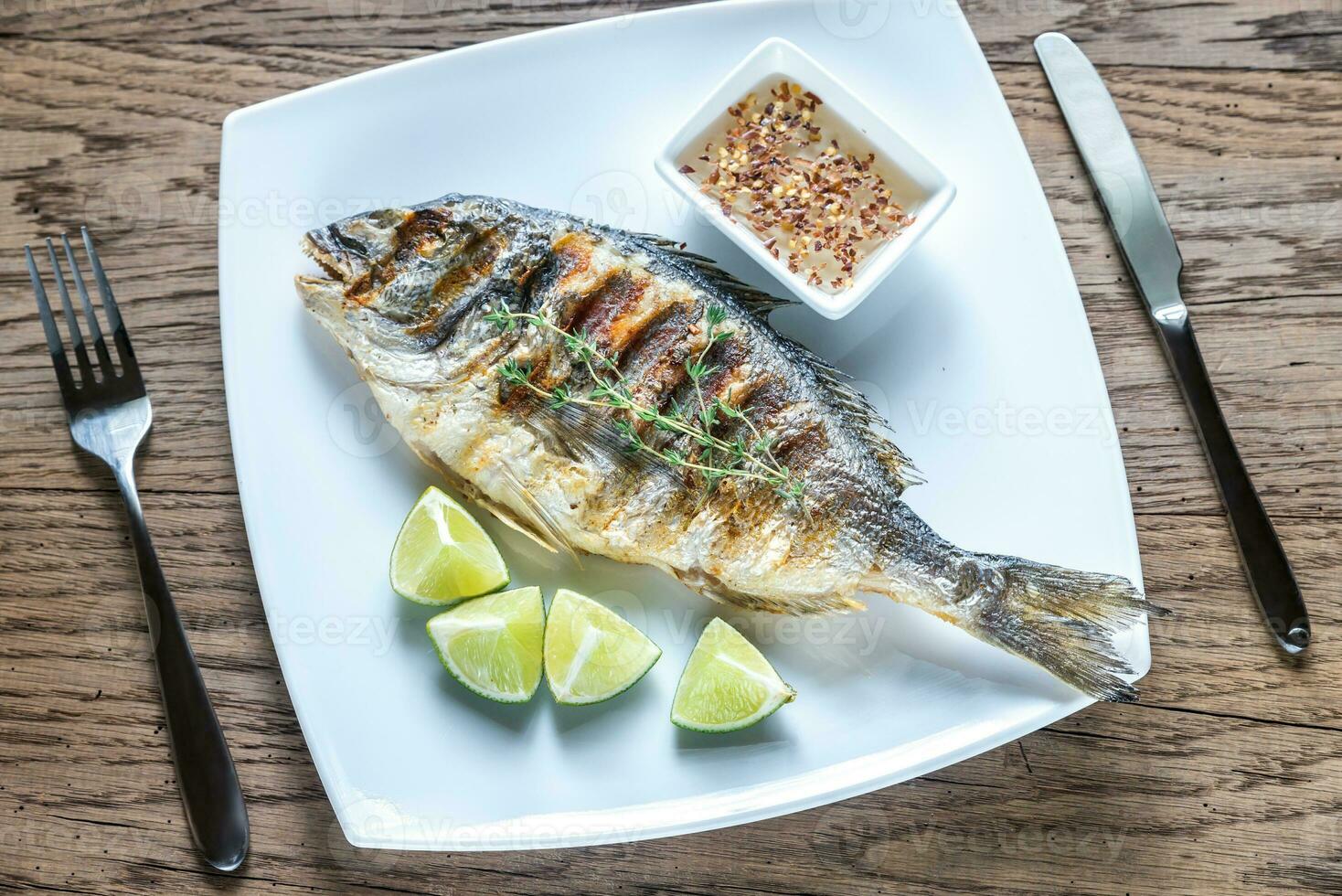 Grilled Dorade Royale Fish on the plate photo