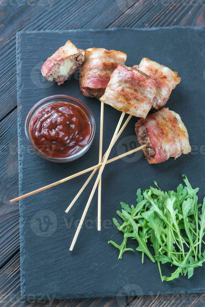 Bacon-wrapped beef skewers stuffed with mozzarella photo