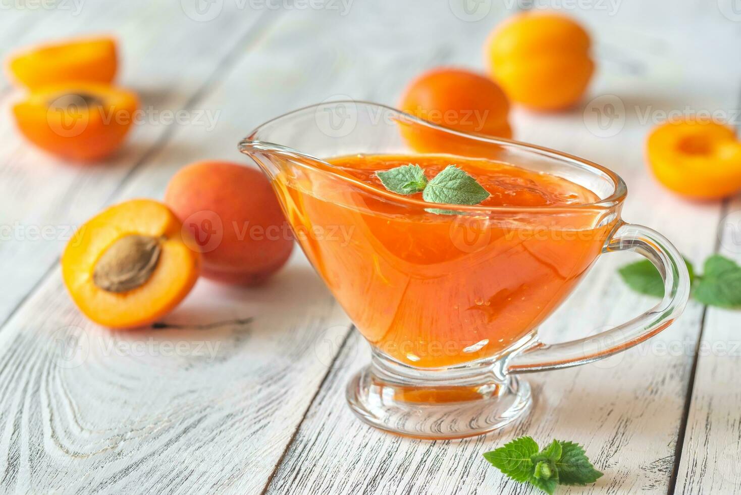 Glass vase of apricot jam photo