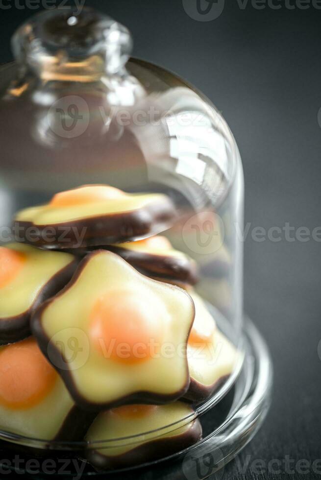 Fondant candies under the glass dome photo
