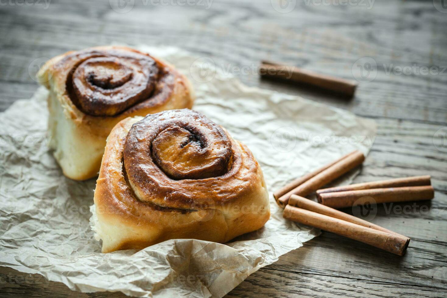 Cinnamon roll on the wooden background photo