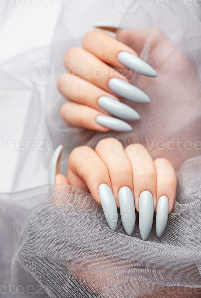 Grey nails on grey lace background. photo