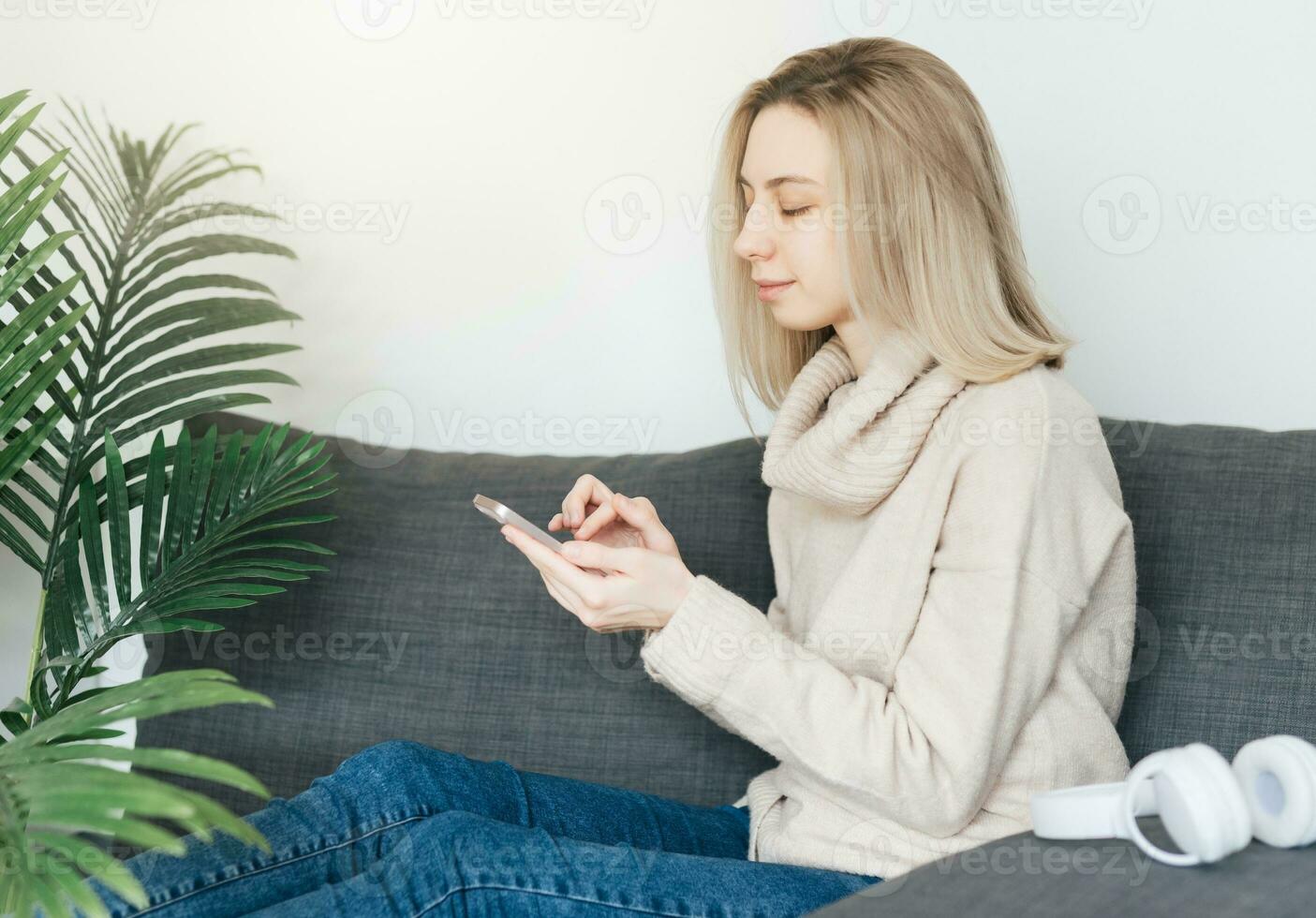 Young woman holding smartphone and banking credit card photo