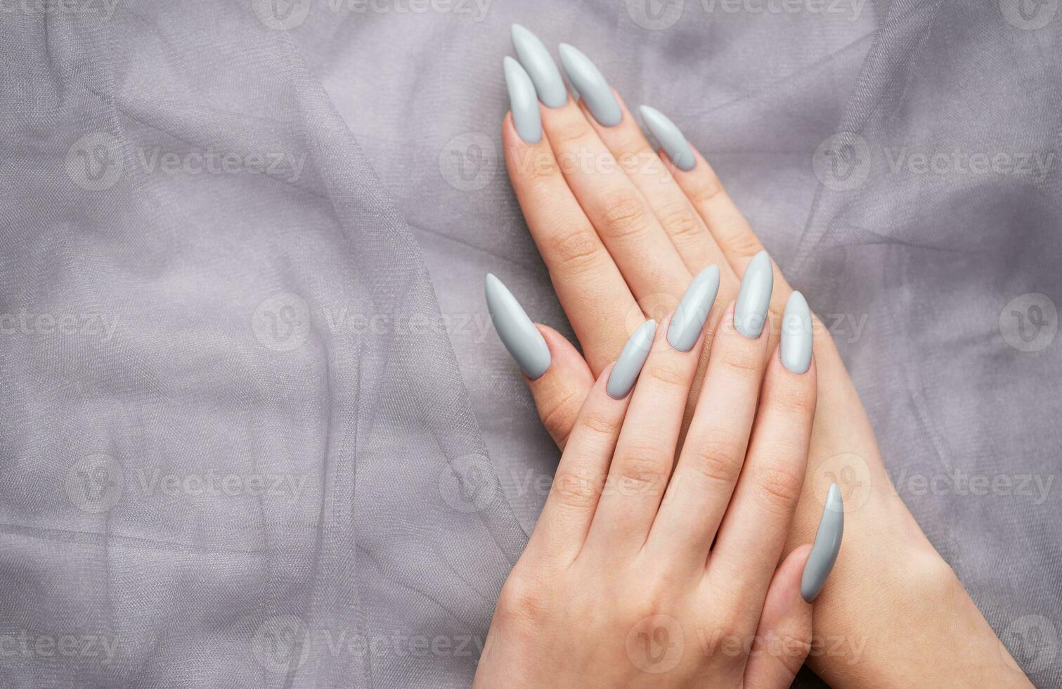 Grey nails on grey lace background. photo