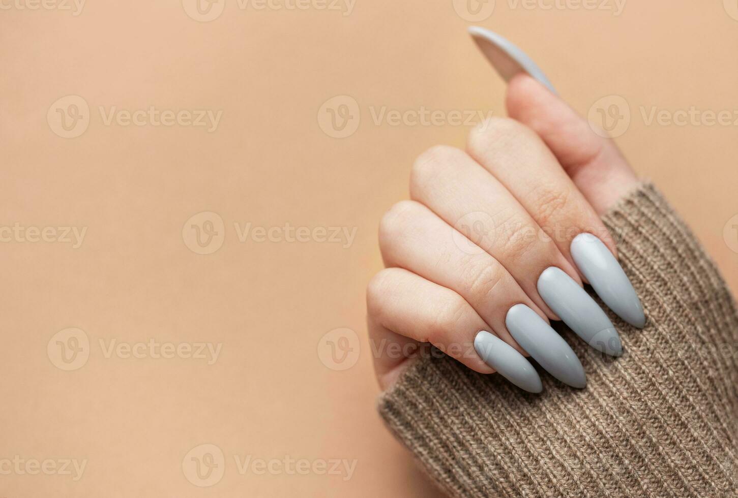 Woman's hand with grey nail polish photo