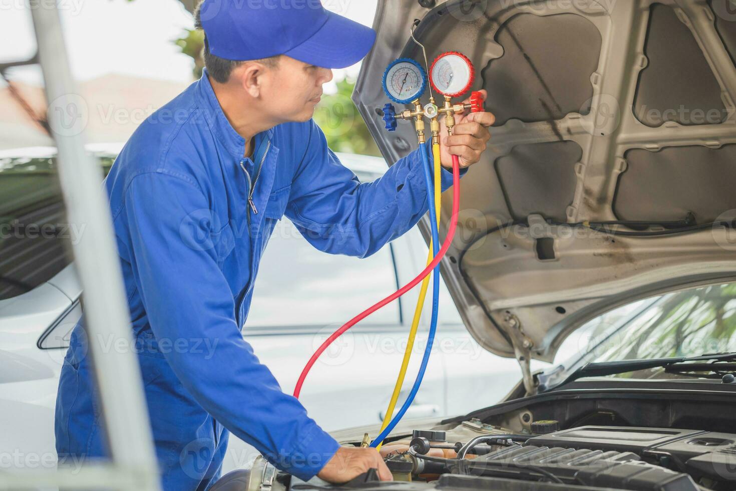 Car Air Conditioning Repair, Technician checked car air conditioning system refrigerant recharge, Repairman check and fixed car air conditioner system photo