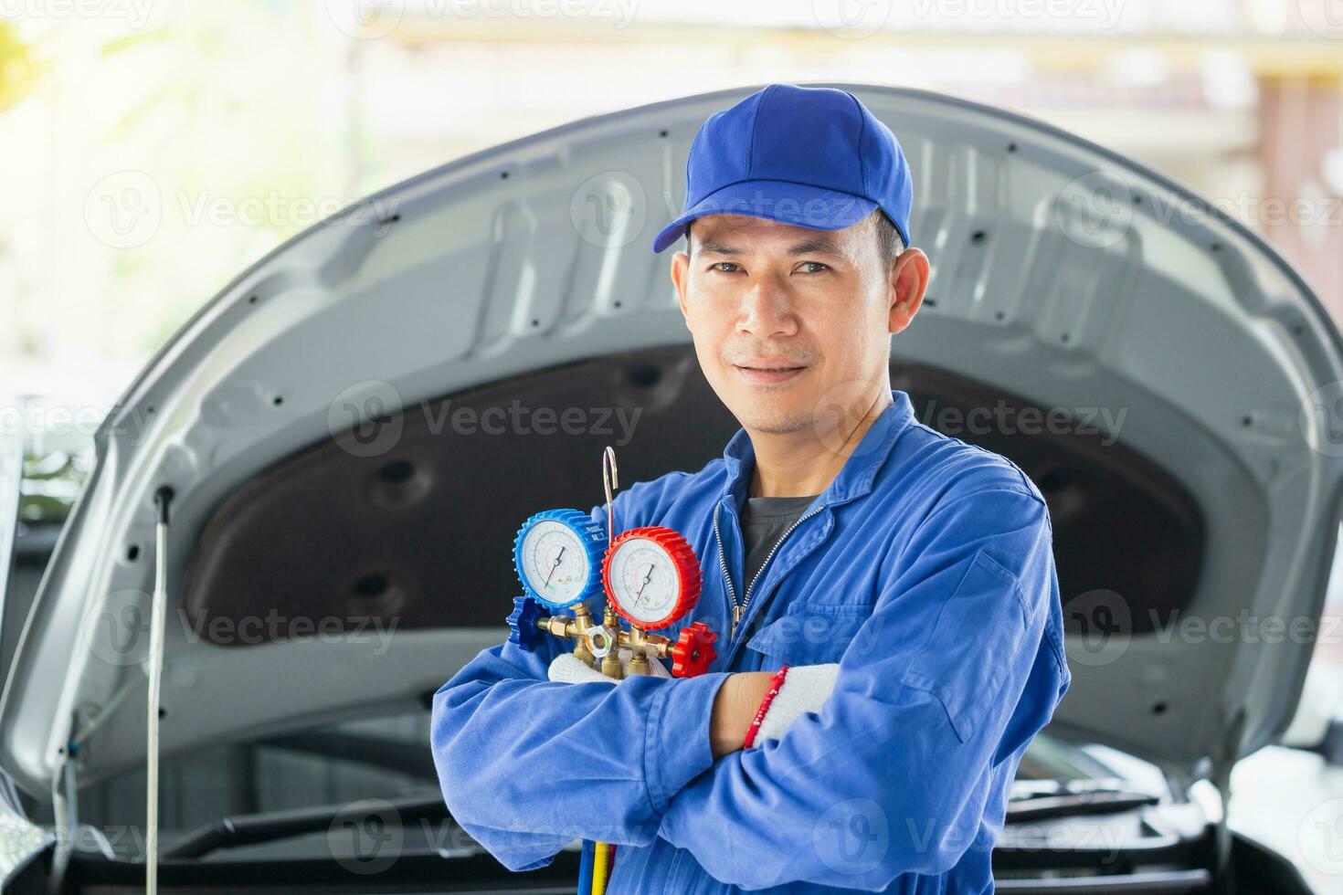 Car Air Conditioning Repair, Repairman holding monitor tool to check and fixed car air conditioner system, Technician check car air conditioning system refrigerant recharge photo