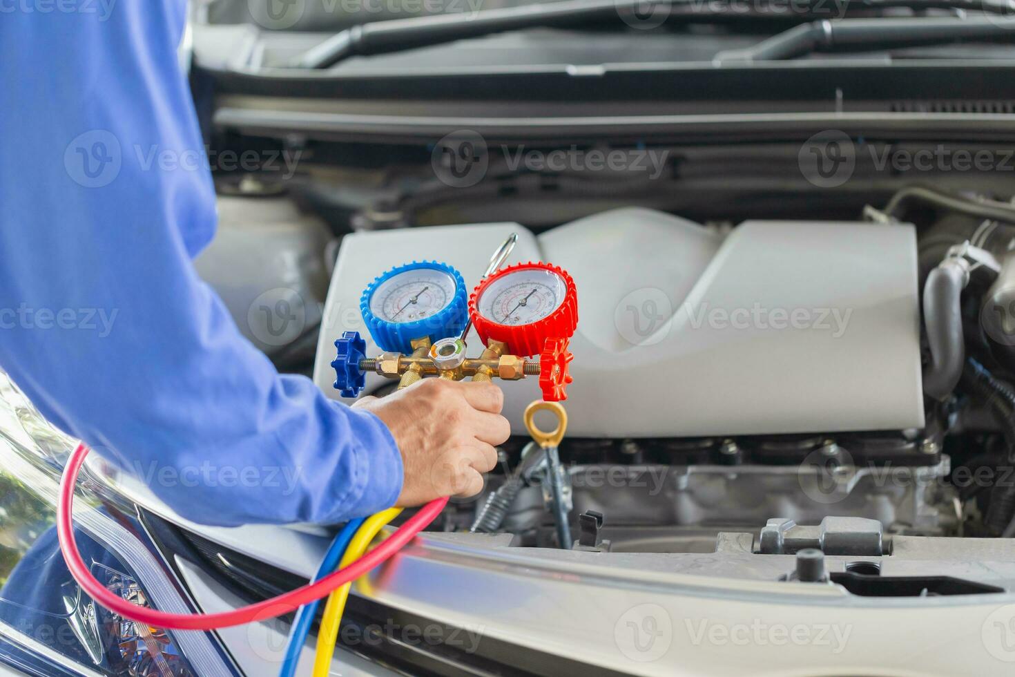 Car Air Conditioning Repair, Technician checked car air conditioning system refrigerant recharge, Repairman check and fixed car air conditioner system photo