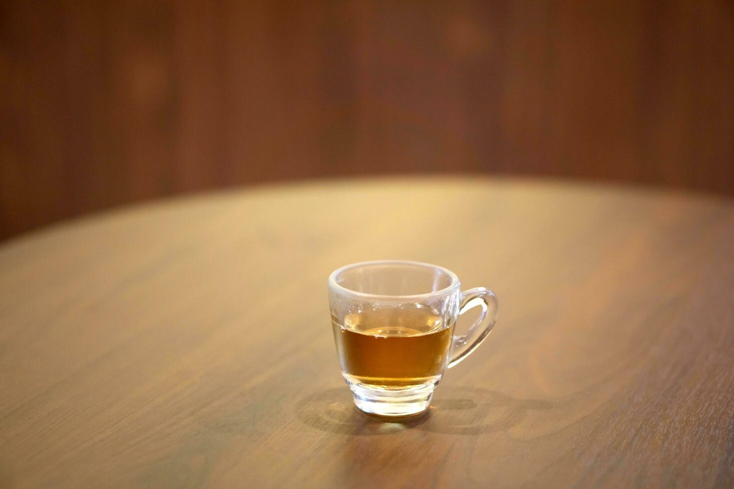 Cup of Lingzhi mushroom hot tea on table. photo