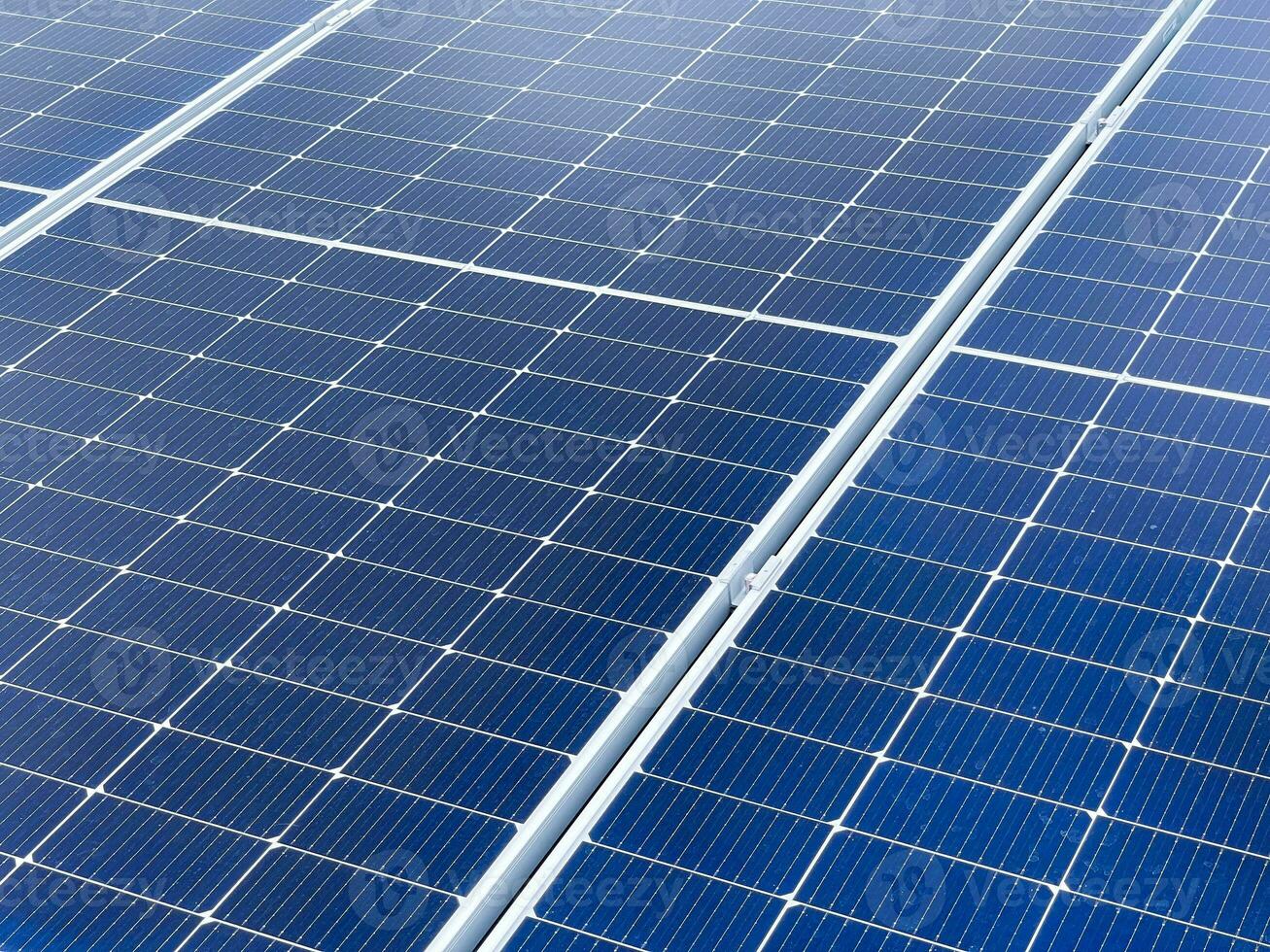 Close-up of Solar cell panel grid, eco technology. landscape of Solar cell panels in a photovoltaic power plant. Concept of sustainable resources and renewable energy. Blue tone. photo
