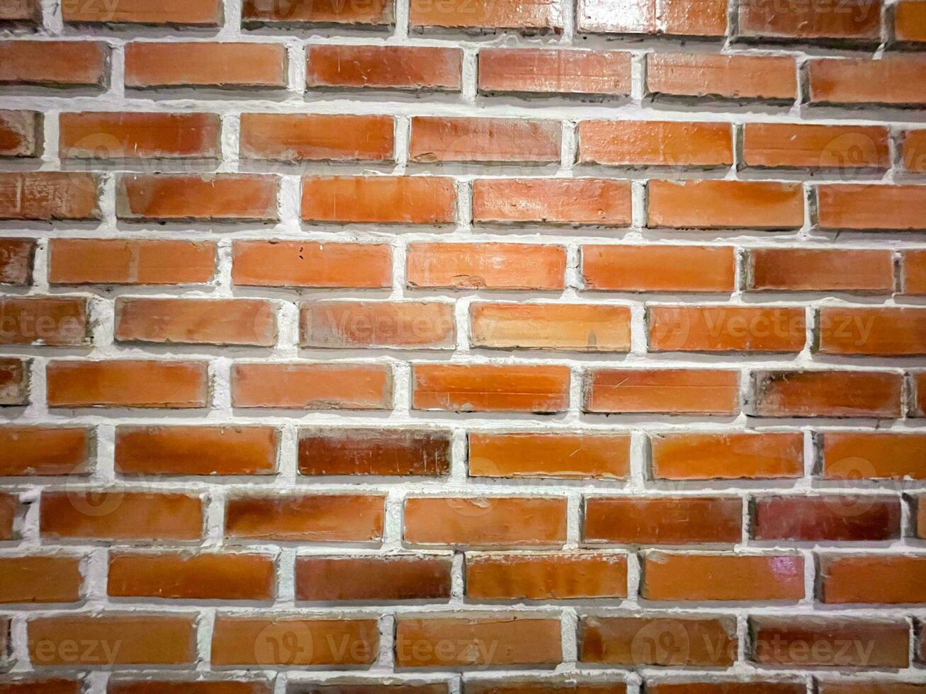 Old wall background with stained aged red bricks photo