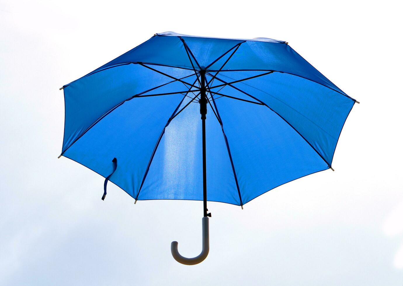 Blue umbrella that was unfolded isolated on white photo