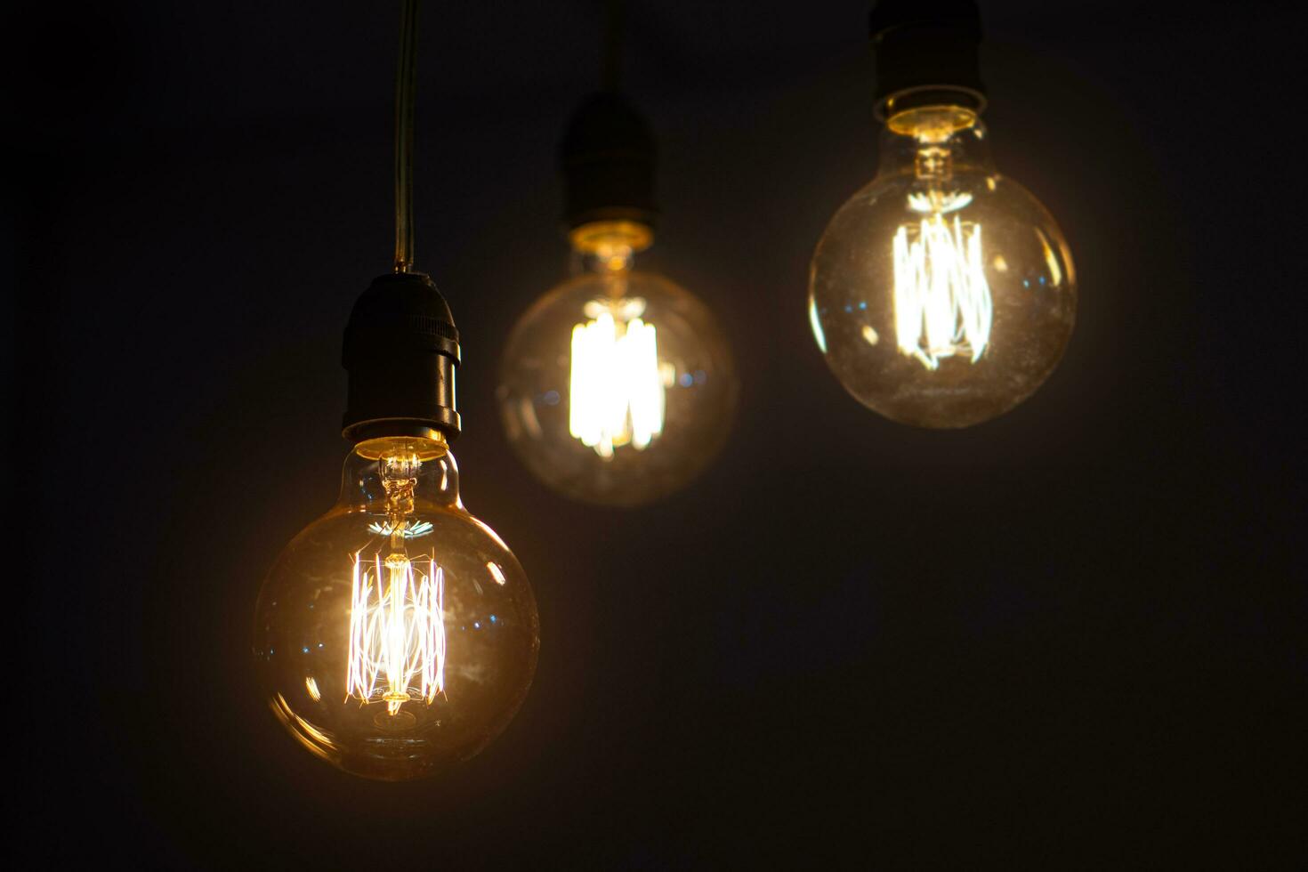 incandescent light bulb on dark background photo