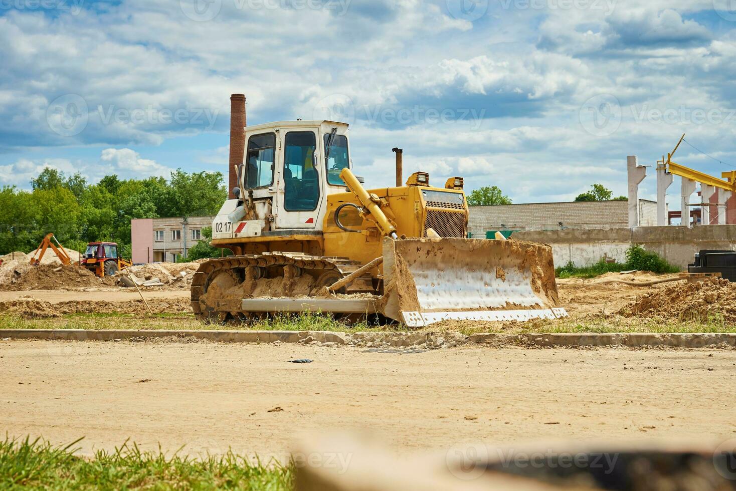 Yellow bulldozer at construction site photo