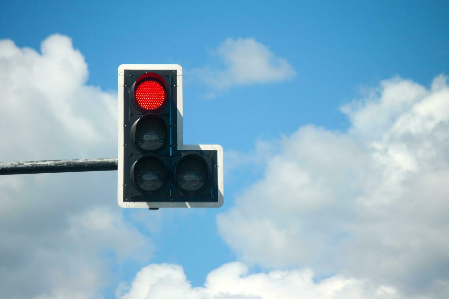 Red light traffic lights against blue sky background. photo