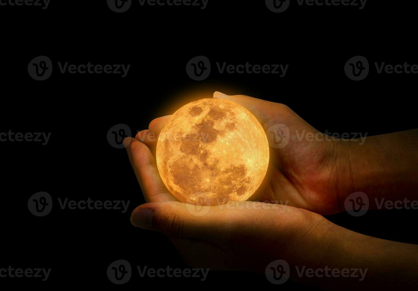 Female hand hold yellow full moon. photo