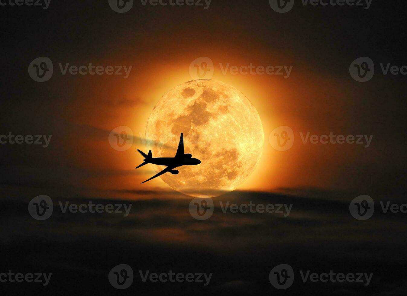 Silhouette airplane flying across the moon photo
