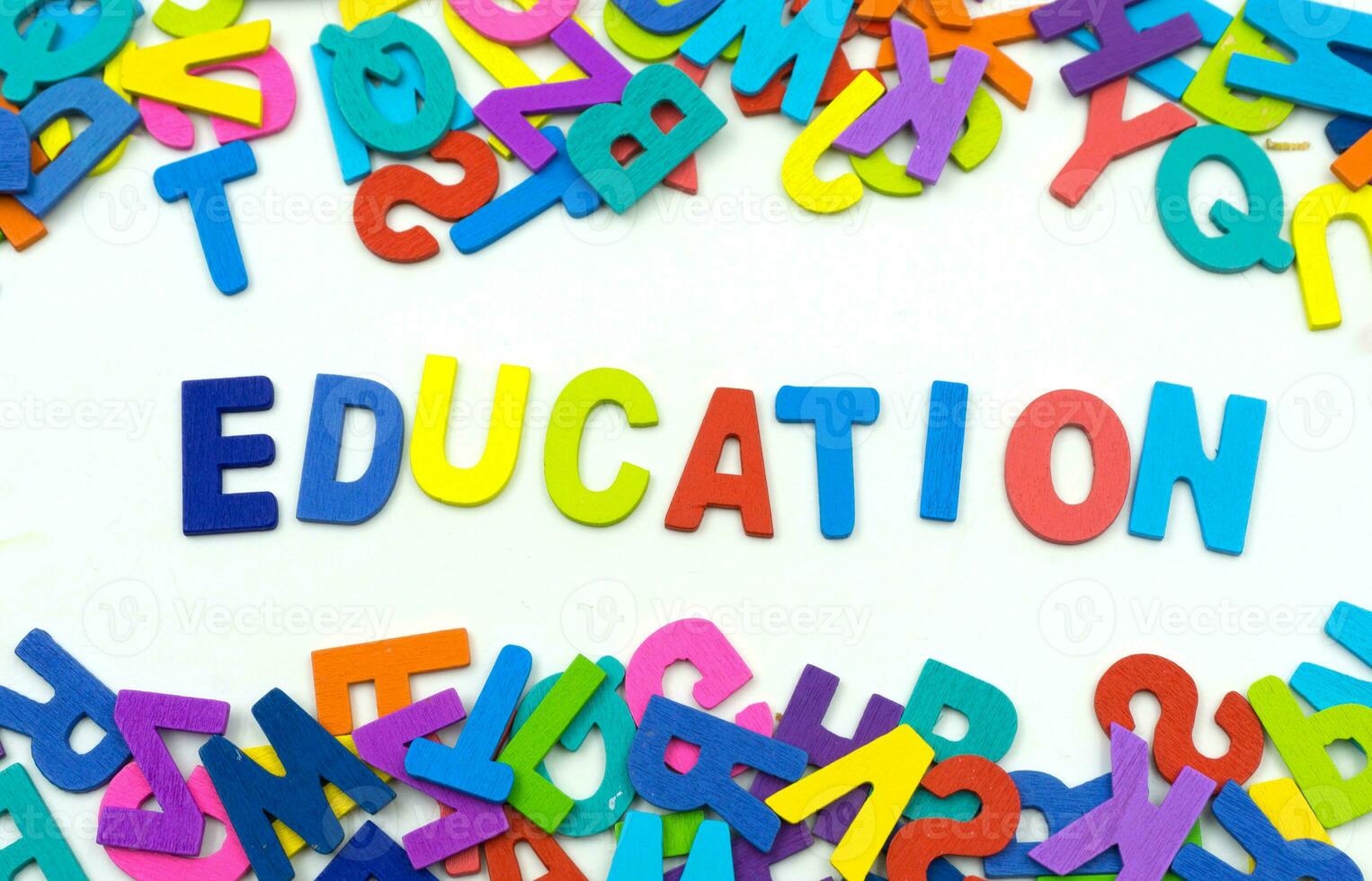 The letters made of plywood the words education are on a white background. photo