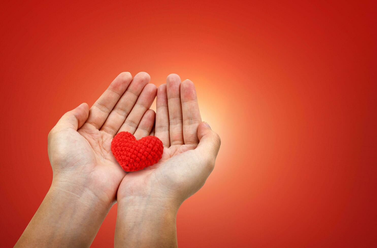 Hands hold red hearts photo