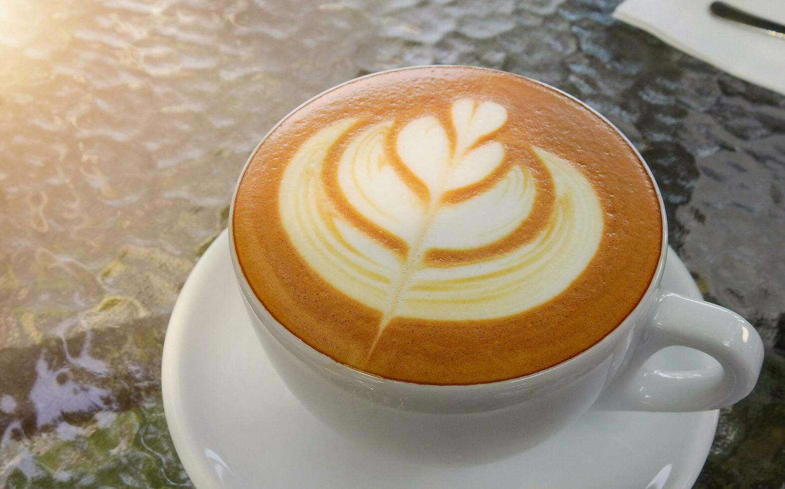 A cup of latte art Coffee in coffee shop photo