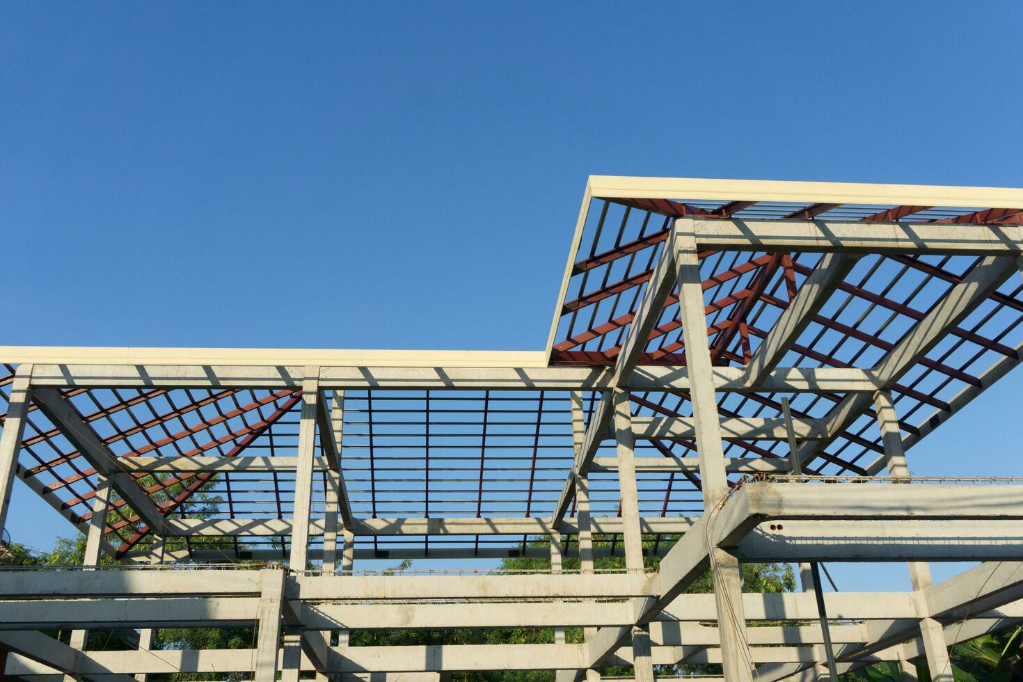 Close-up of roof construction home framing against blue sky photo