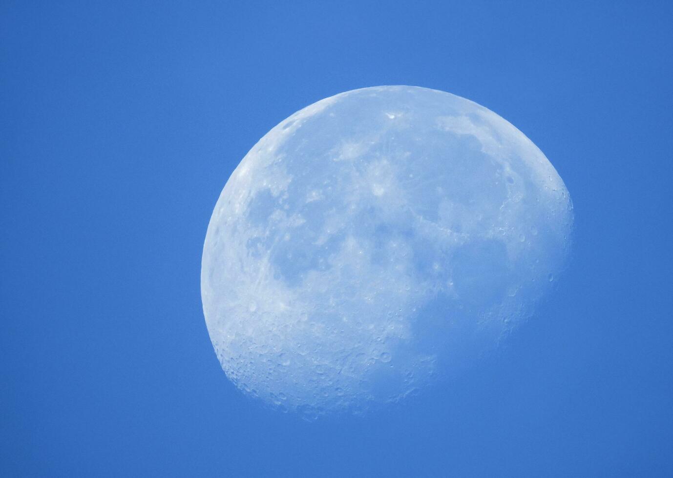 Phase of the moon in daytime. photo