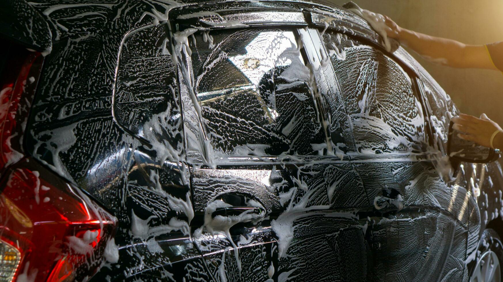 Selective focus of Black Car wash with soap photo