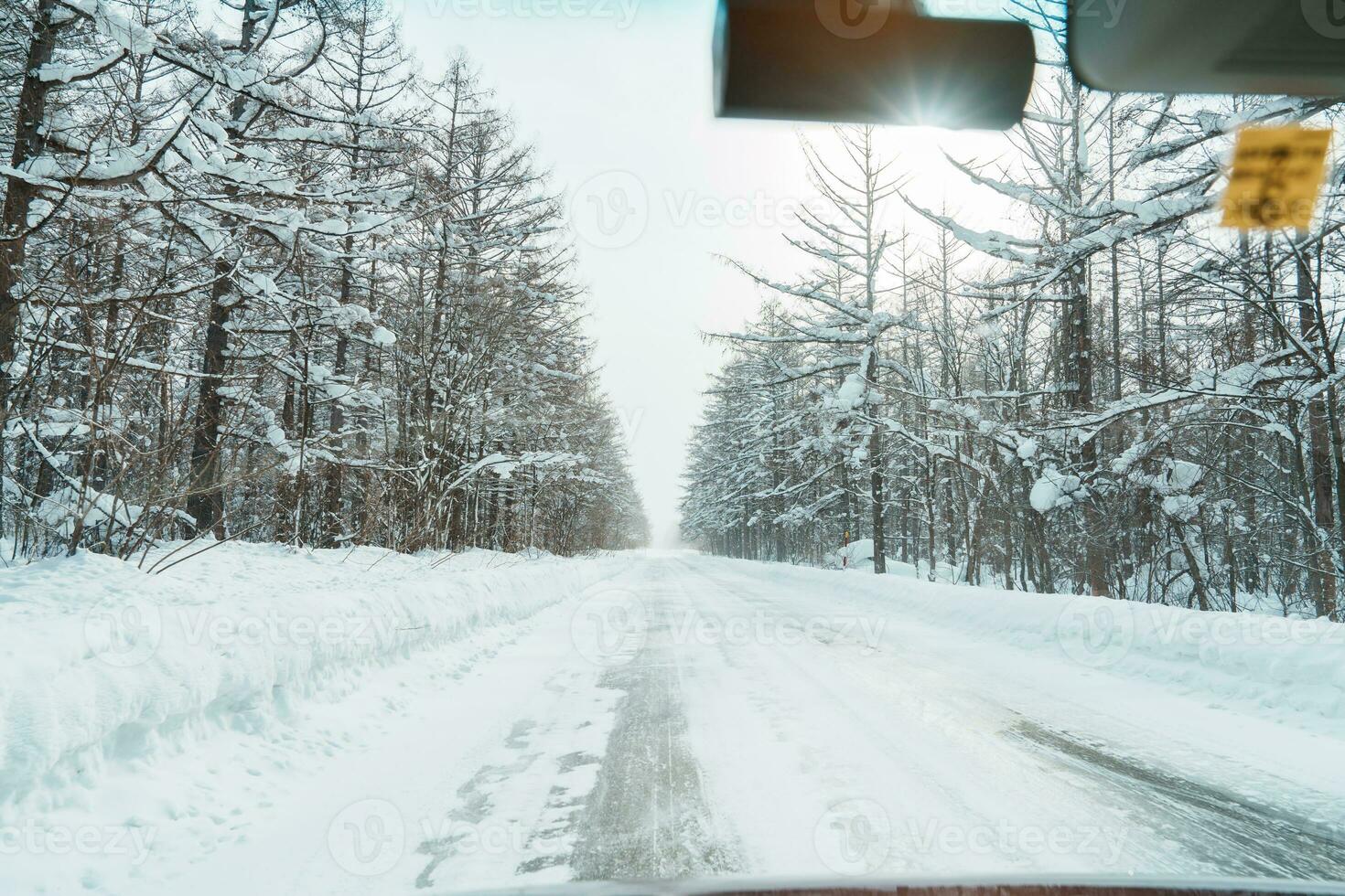 Beautiful snow road forest view during car driving in winter season. Winter travel, Road trip, Adventure, Exploring and Vacation concepts photo