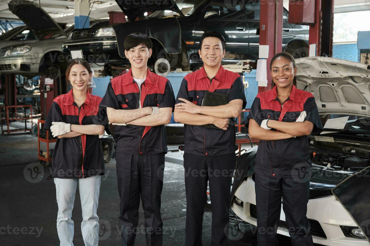 Portrait of multiracial professional mechanic team arms crossed and look at camera, work at car service garage, happy maintenance jobs, check and repair occupation in automotive industry business. photo