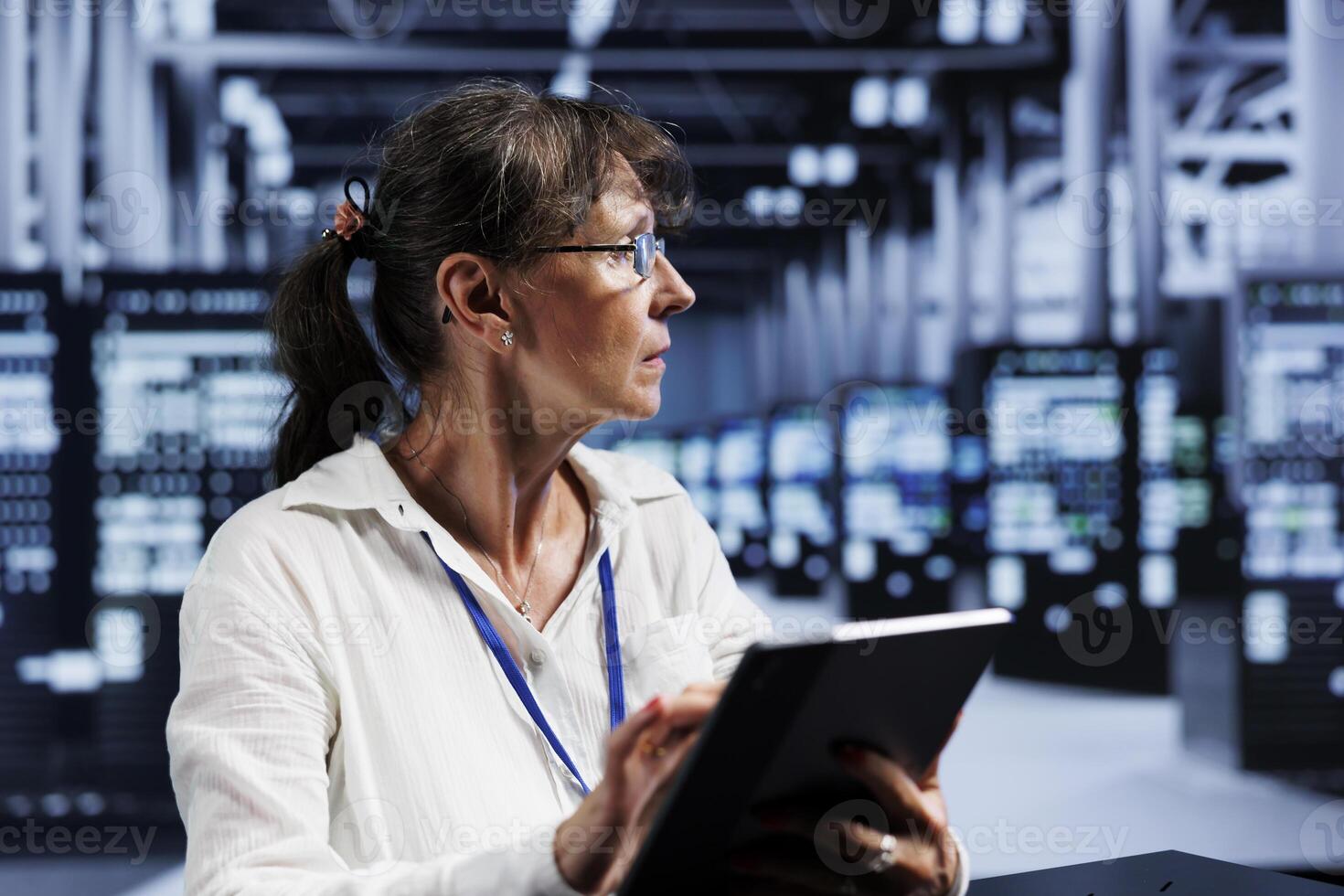 Elderly efficient admin updating data center units, writing intricate binary code scripts on tablet, using programming to fortify cybersecurity in technically advanced server farm photo