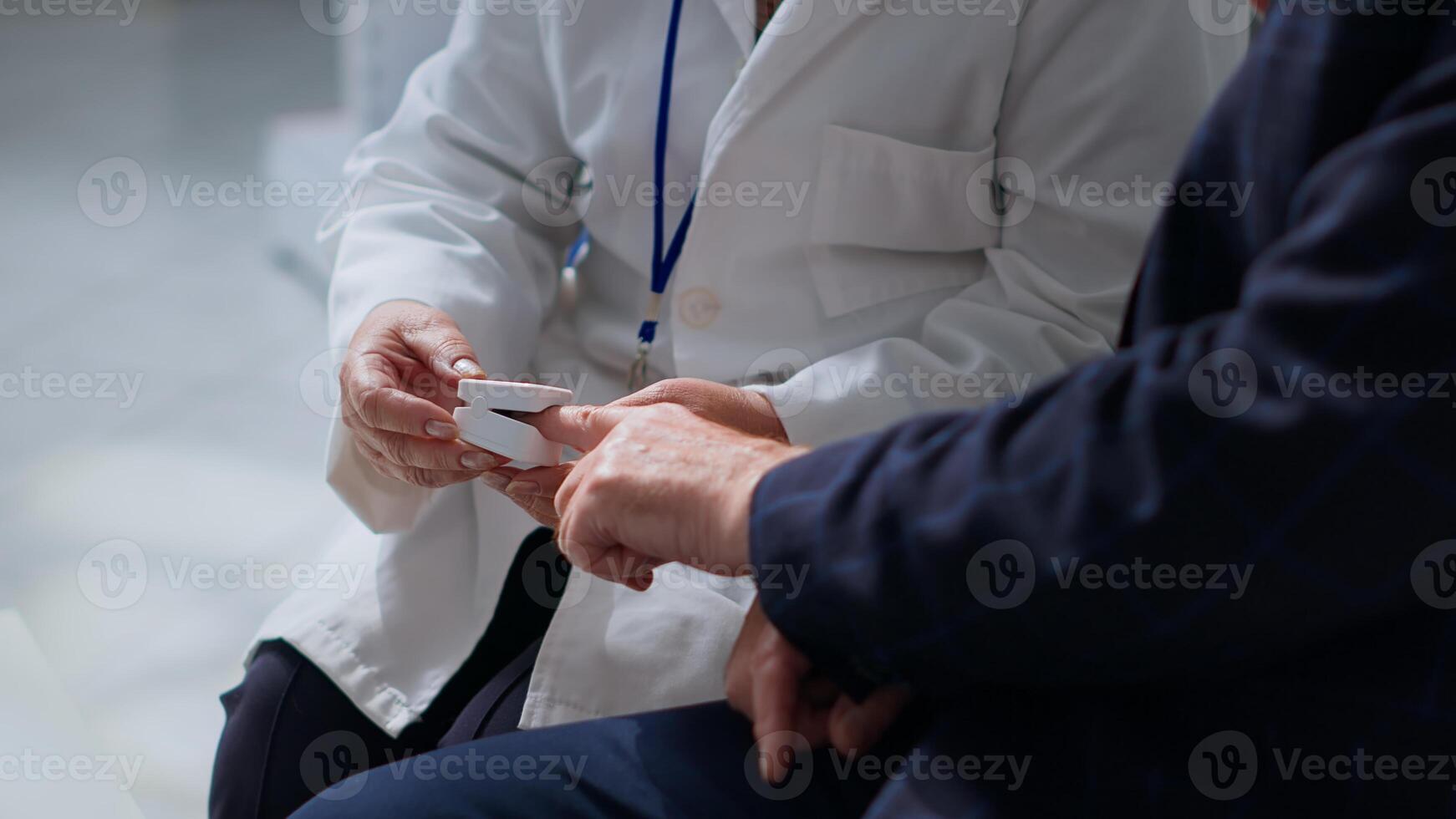 Close up of specialist clipping patient finger using pulse oximeter, monitoring level of blood oxygen saturation and heart rate during consultation in chemist store offering full range of services photo