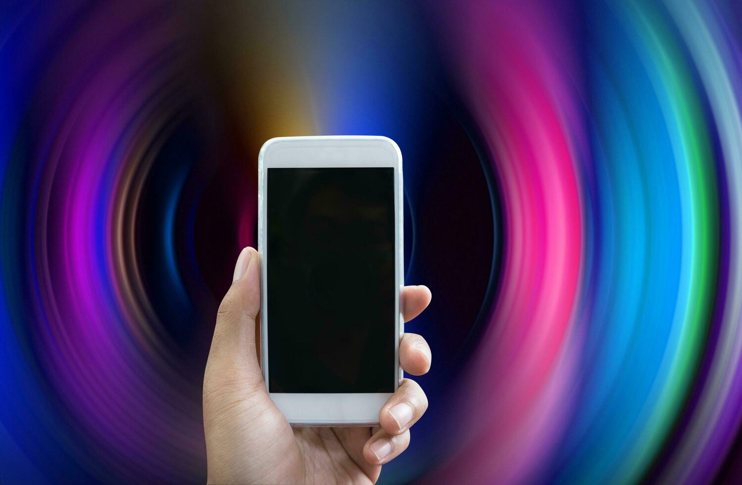 Man's hand shows white smartphone in vertical position photo