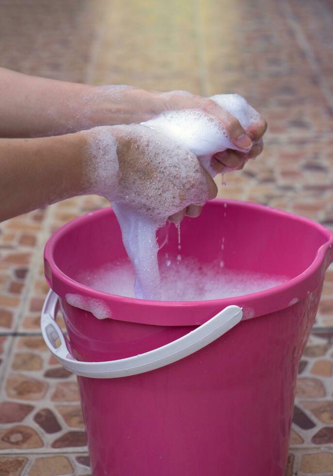 Hand Twist clothes in the basin. photo