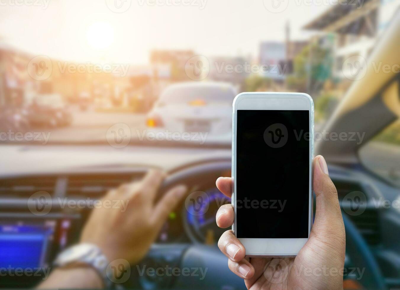 Using a smartphone while driving a car photo