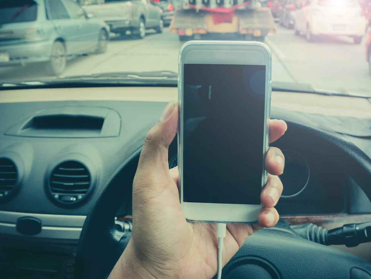 using a smartphone while driving a car photo