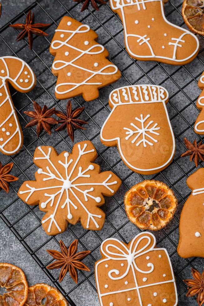 Beautiful delicious sweet winter Christmas gingerbread cookies on a gray textured background photo