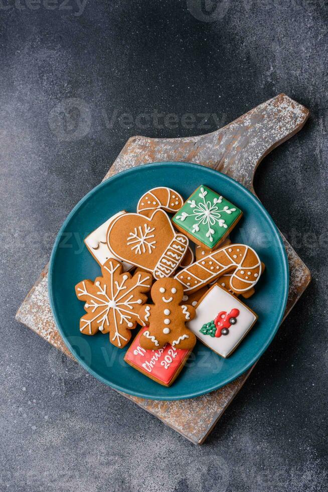 Beautiful delicious sweet winter Christmas gingerbread cookies on a gray textured background photo