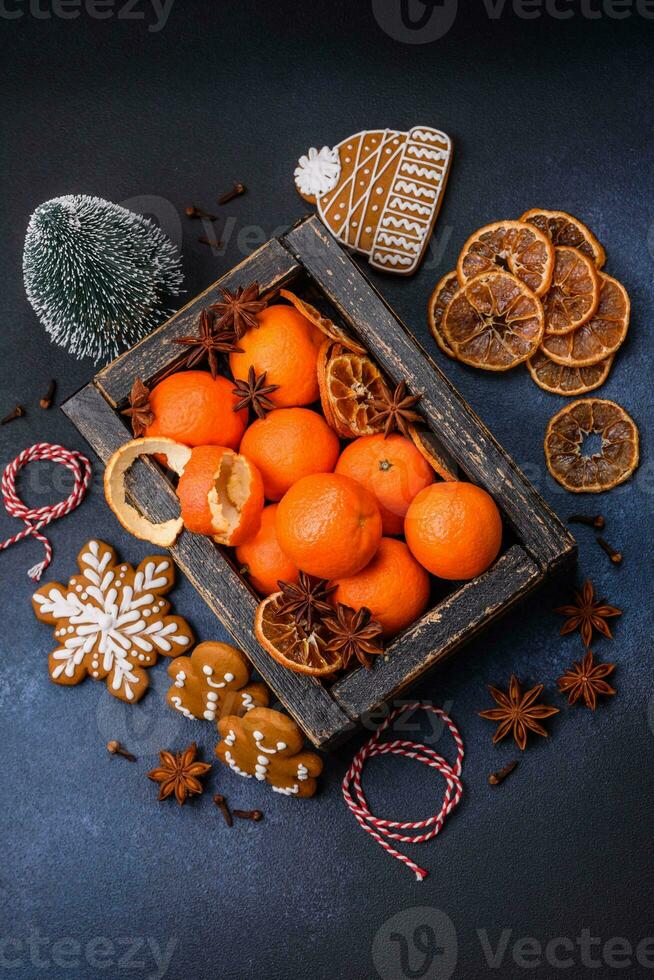 Beautiful festive Christmas composition of tangerines, gingerbread and star anise photo