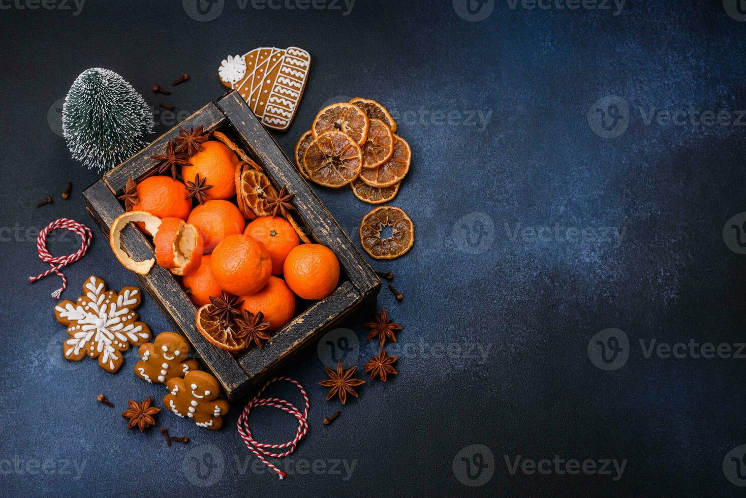 Beautiful festive Christmas composition of tangerines, gingerbread and star anise photo