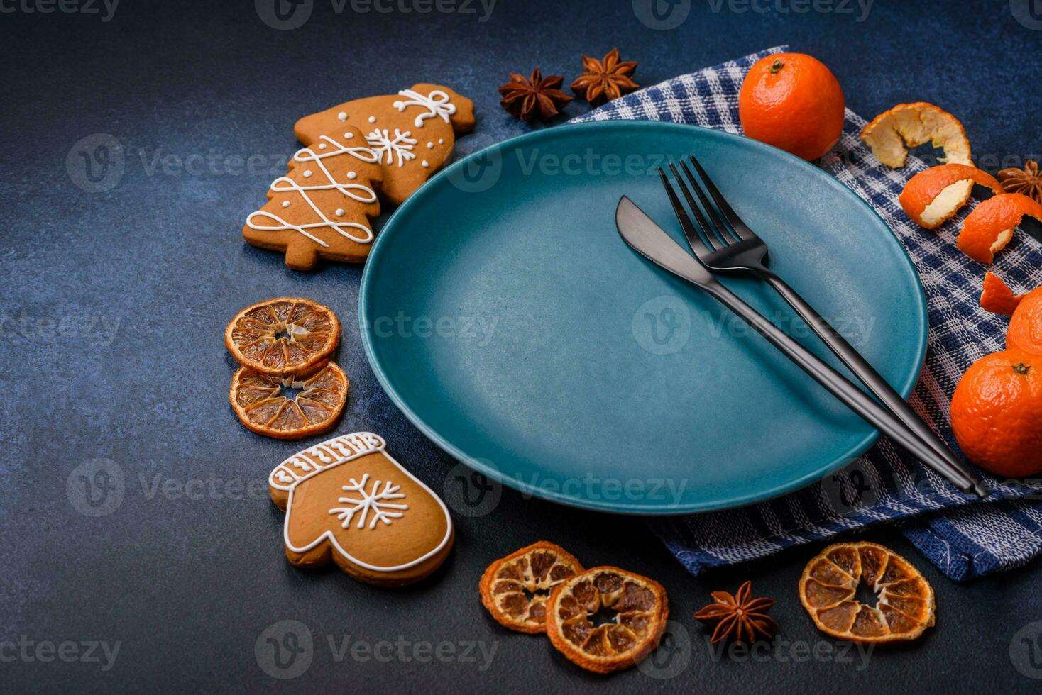 Beautiful festive Christmas composition of an empty plate, tangerine and gingerbreads photo