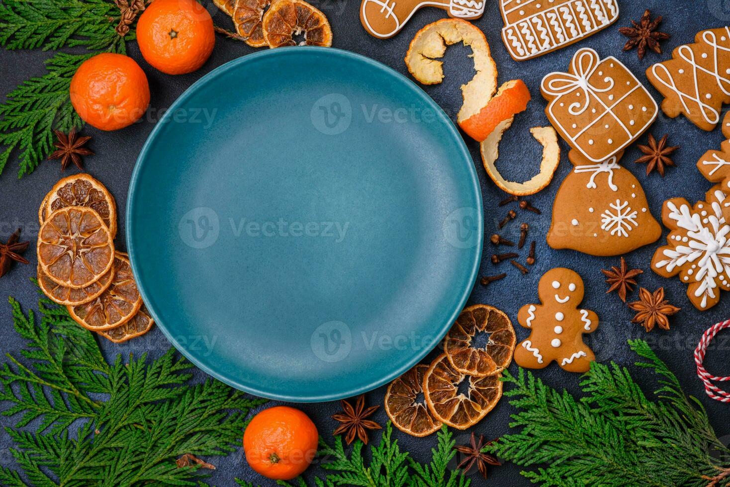 Beautiful festive Christmas composition of an empty plate, tangerine and gingerbreads photo