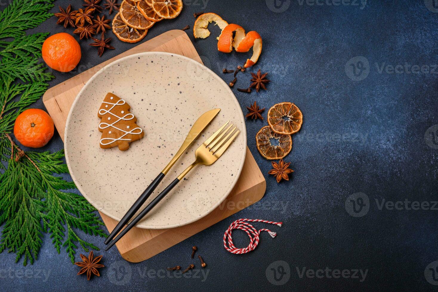 Beautiful festive Christmas composition of an empty plate, tangerine and gingerbreads photo