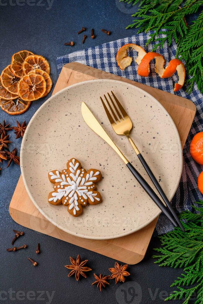 Beautiful festive Christmas composition of an empty plate, tangerine and gingerbreads photo