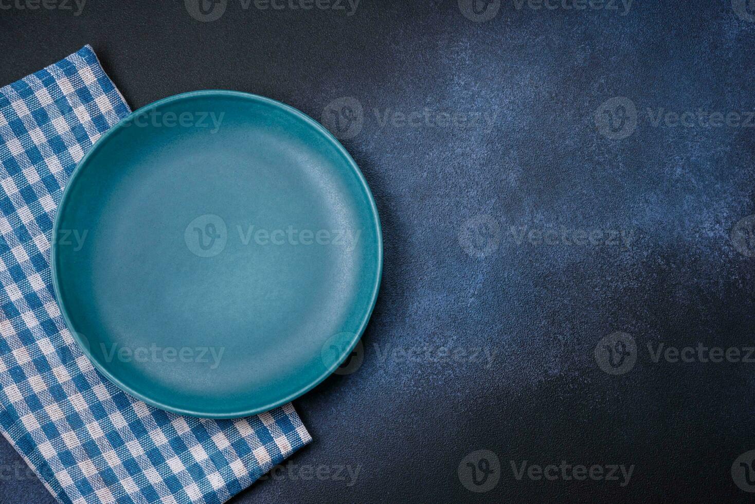 Round empty colored ceramic plate on concrete texture background photo