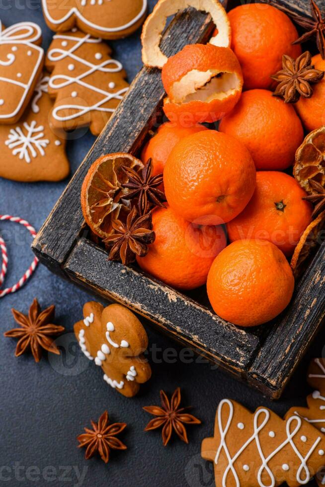 Beautiful festive Christmas composition of tangerines, gingerbread and star anise photo