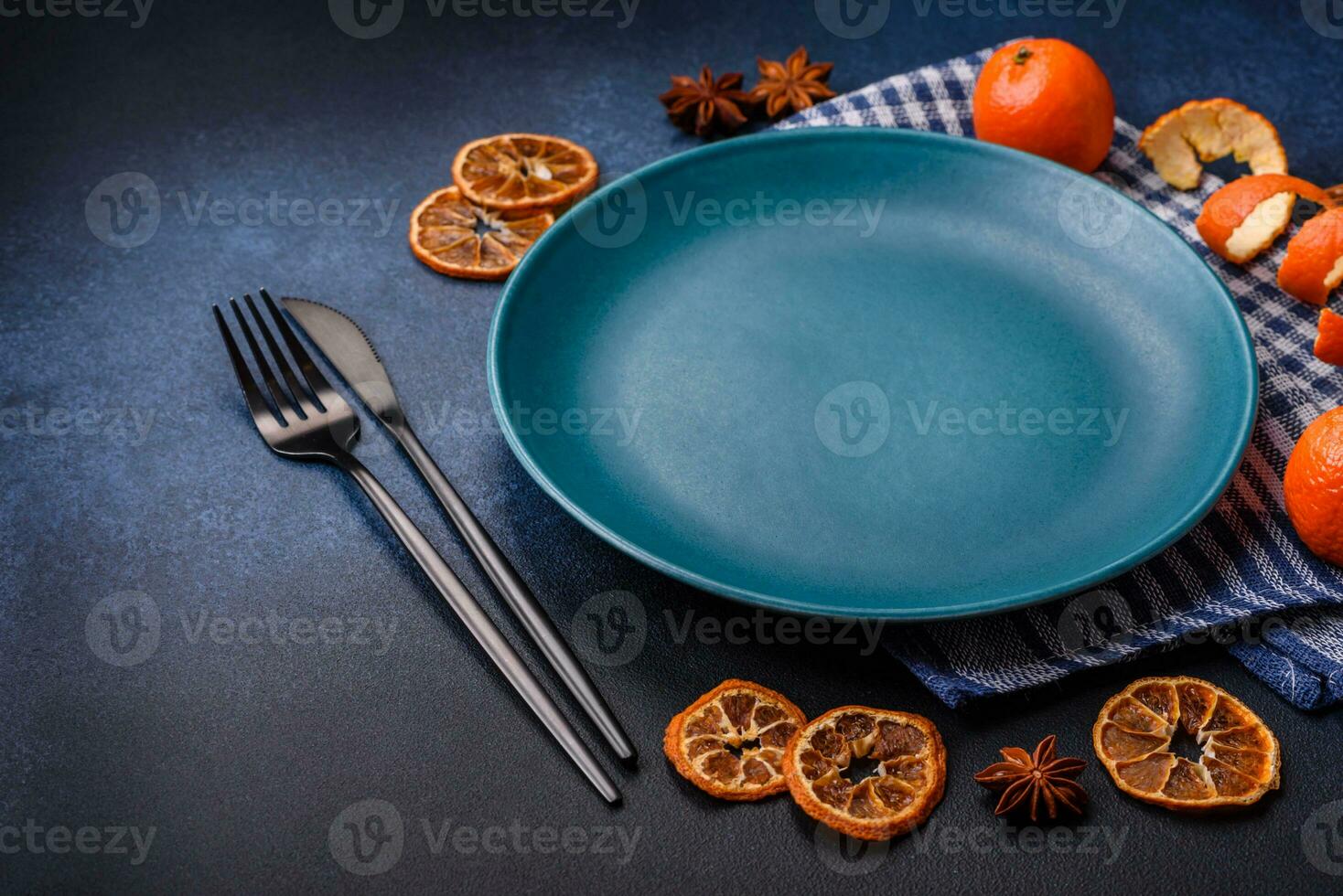 Beautiful festive Christmas composition of an empty plate, tangerine and gingerbreads photo