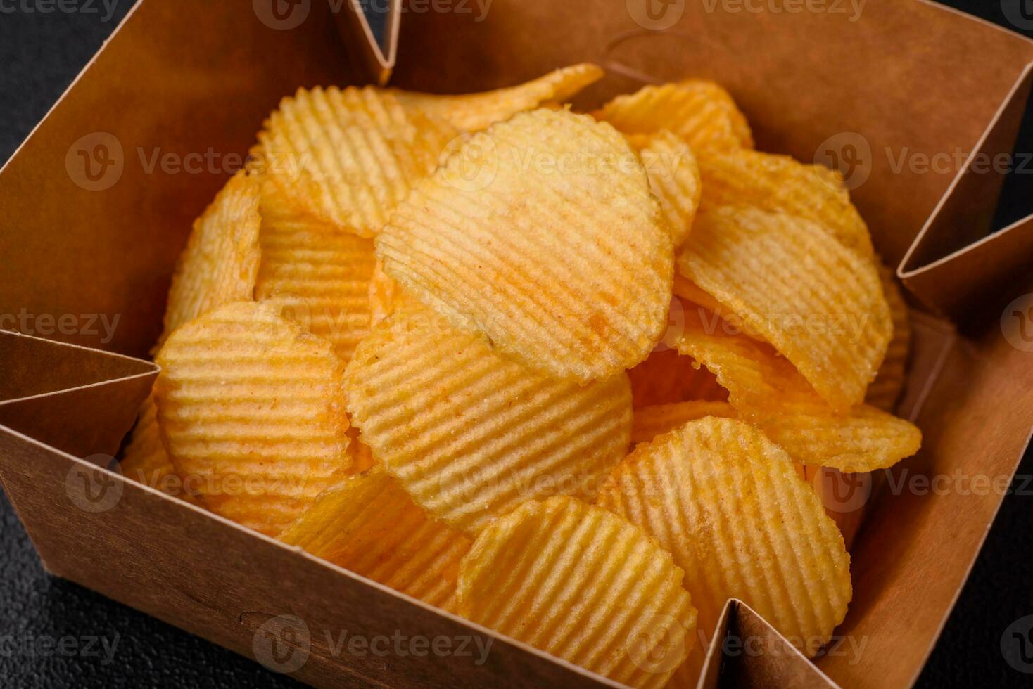 Crispy potato chips with salt, spices and herbs photo