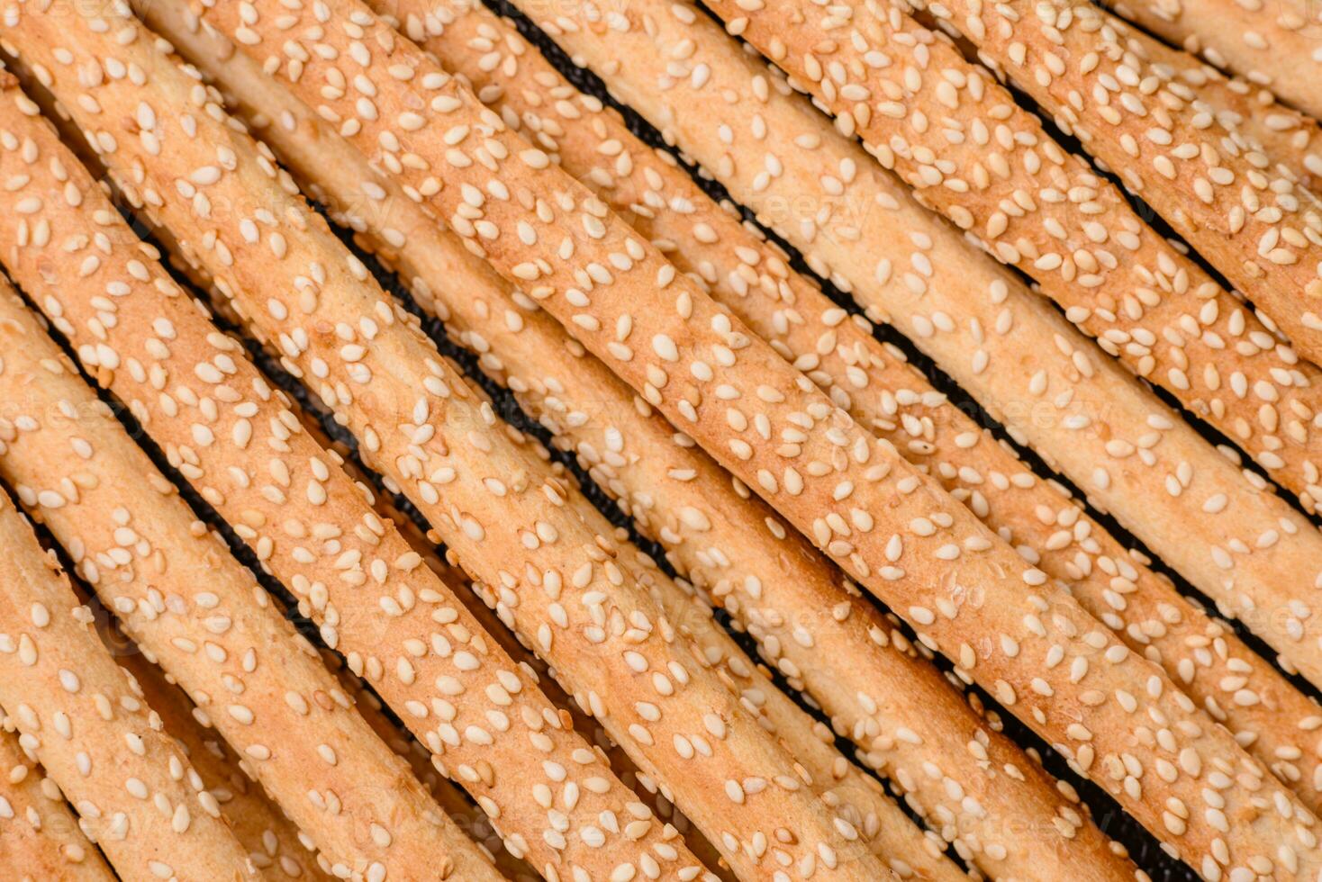 Delicious fresh grissini sticks with salt and sesame seeds photo