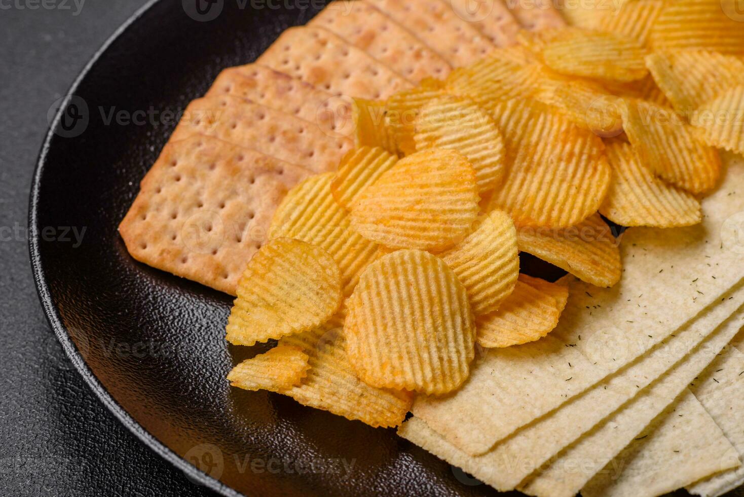 Crispy potato chips with salt, spices and herbs photo